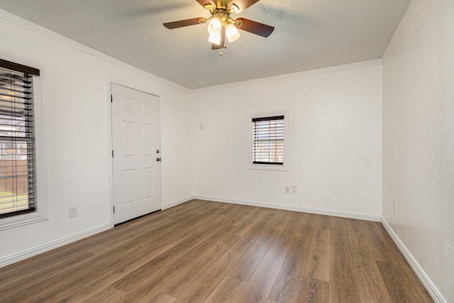 spare room with ceiling fan, hardwood / wood-style flooring, ornamental molding, and a textured ceiling