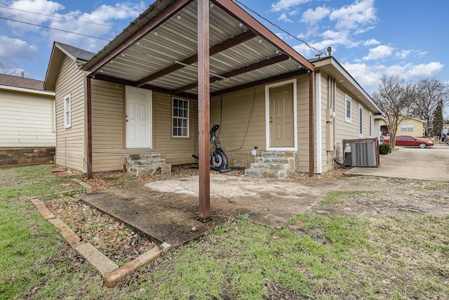 rear view of house featuring central air condition unit