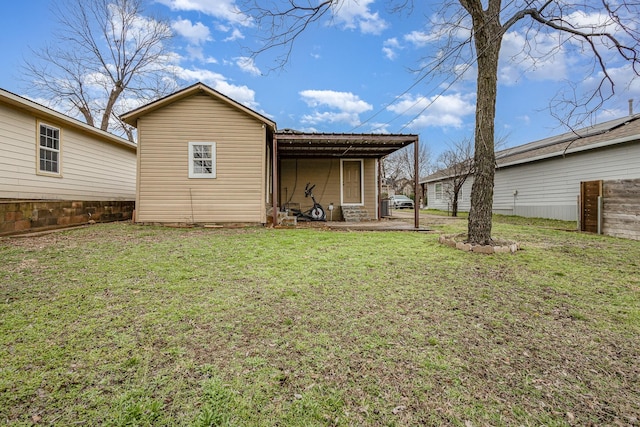 rear view of house featuring a yard