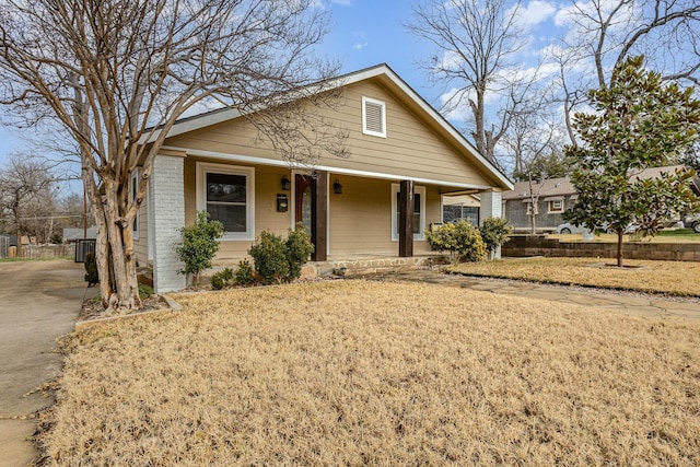 bungalow-style home with a porch and a front yard