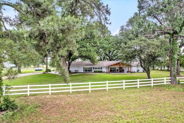 view of front facade with a rural view and a front yard