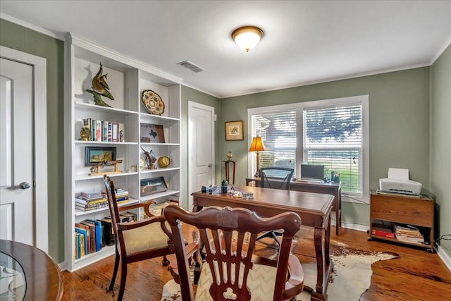 office space featuring hardwood / wood-style flooring and crown molding