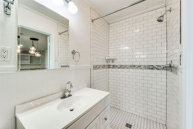 bathroom with vanity and a tile shower