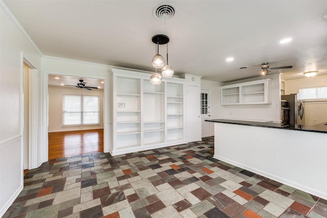 kitchen featuring white cabinetry, hanging light fixtures, crown molding, and ceiling fan