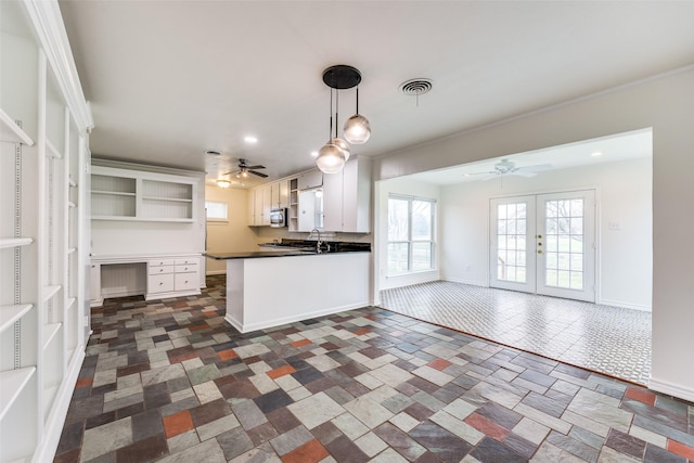 kitchen featuring white cabinetry, pendant lighting, kitchen peninsula, and french doors