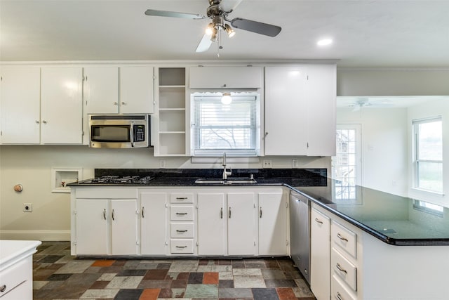 kitchen with appliances with stainless steel finishes, sink, and white cabinets