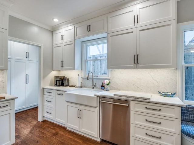 kitchen featuring dark hardwood / wood-style floors, tasteful backsplash, white cabinetry, dishwasher, and sink