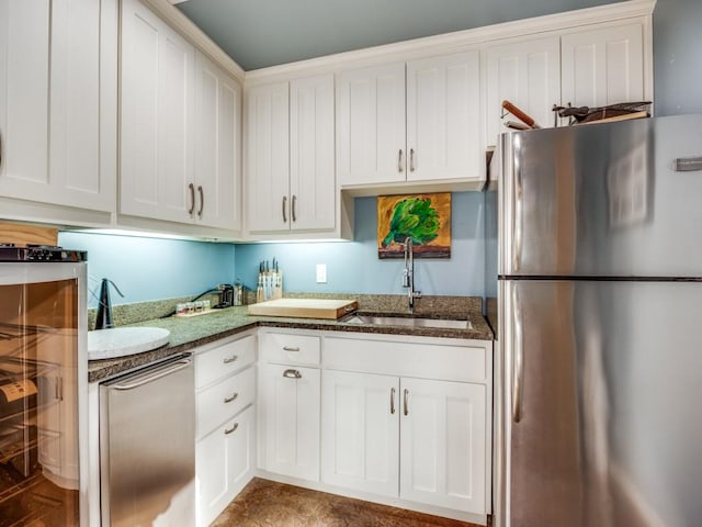 kitchen with sink, stainless steel appliances, and white cabinets