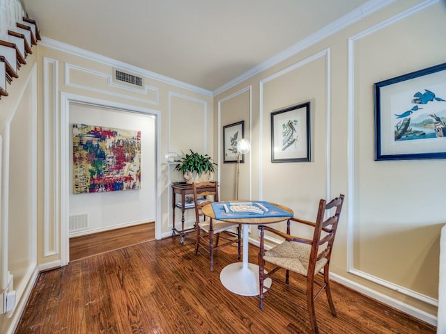 dining area with crown molding and hardwood / wood-style flooring