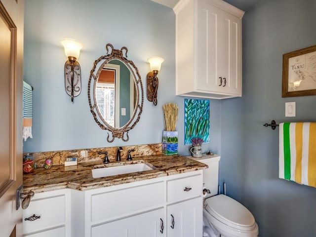 bathroom featuring vanity and toilet