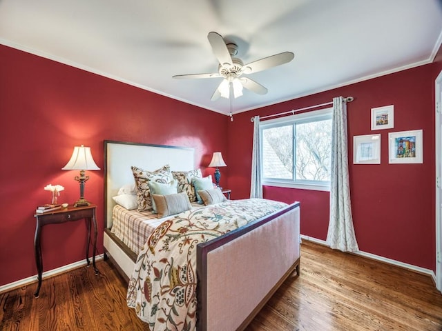 bedroom featuring hardwood / wood-style flooring, ceiling fan, and ornamental molding