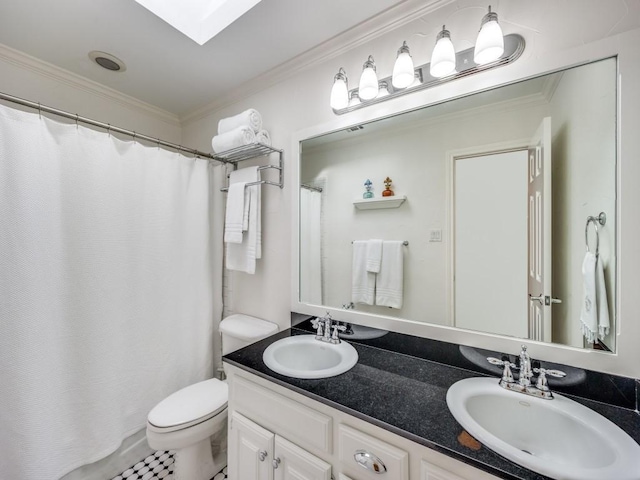 bathroom featuring vanity, a skylight, ornamental molding, and toilet