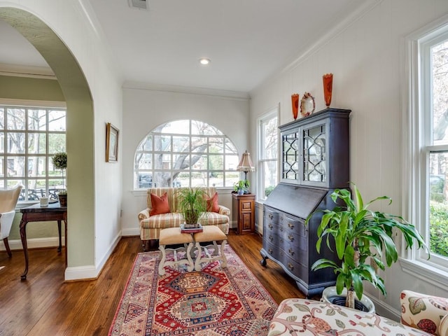 sitting room with ornamental molding and dark hardwood / wood-style flooring