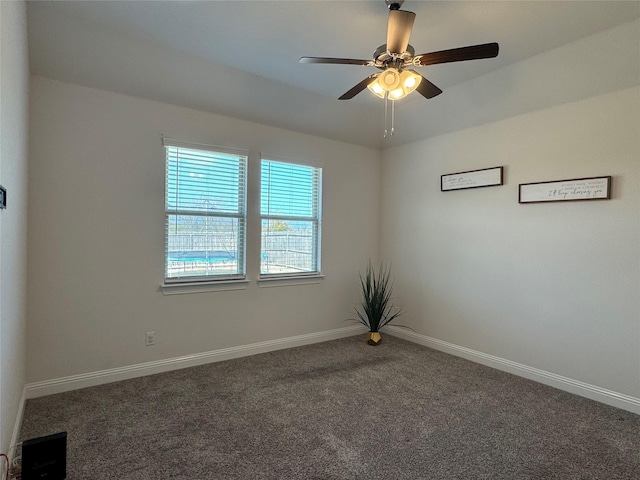 carpeted empty room featuring ceiling fan