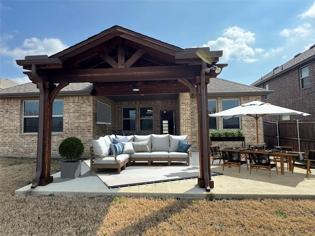 rear view of property featuring outdoor lounge area and a patio area