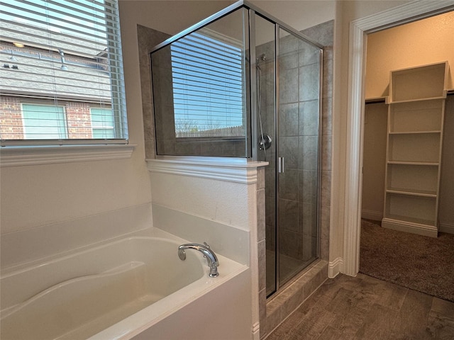 bathroom featuring hardwood / wood-style flooring and shower with separate bathtub