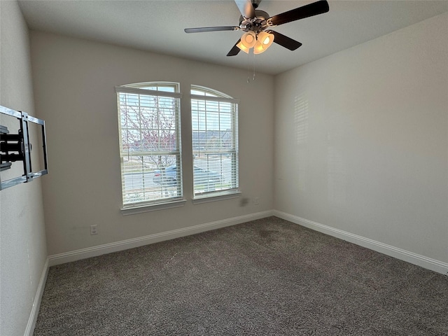 carpeted spare room featuring ceiling fan