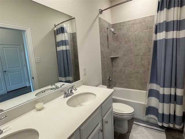 full bathroom featuring toilet, vanity, and shower / bathtub combination with curtain