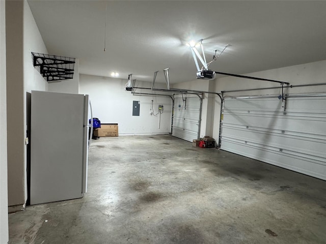 garage with electric panel, refrigerator, and a garage door opener