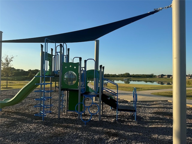 view of playground with a water view