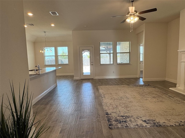 entrance foyer with sink, dark wood-type flooring, and ceiling fan with notable chandelier