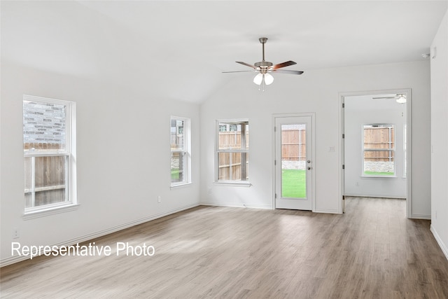 unfurnished living room featuring a wealth of natural light, ceiling fan, and light hardwood / wood-style flooring