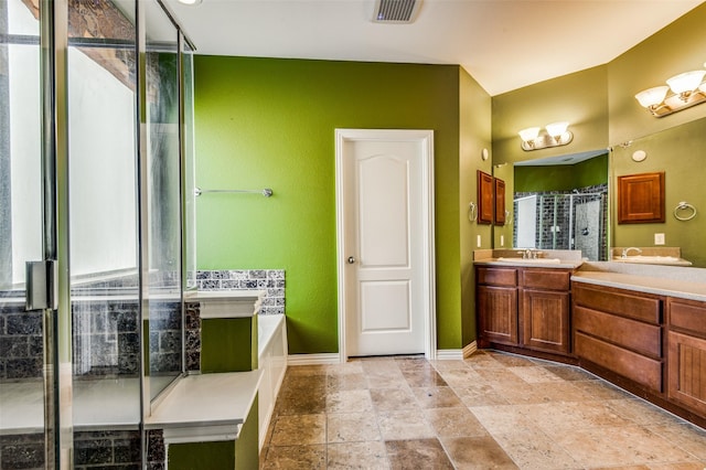 bathroom with vanity and independent shower and bath