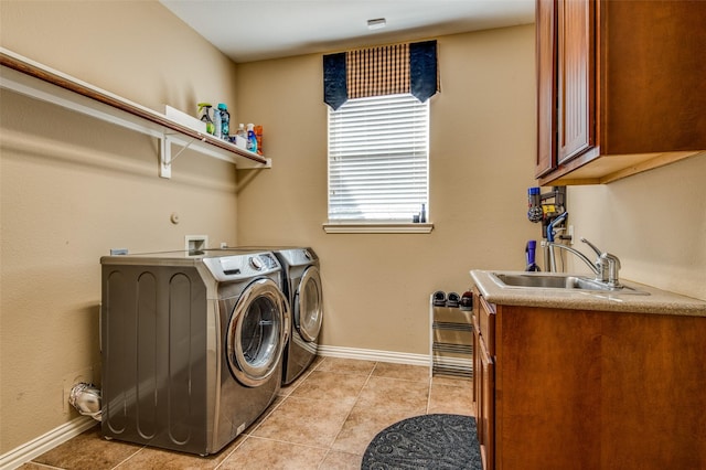 laundry area featuring cabinets, separate washer and dryer, sink, and light tile patterned floors