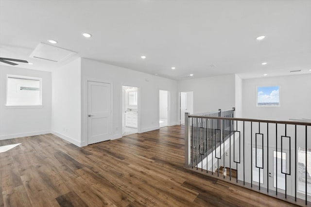 interior space with wood finished floors, attic access, and recessed lighting