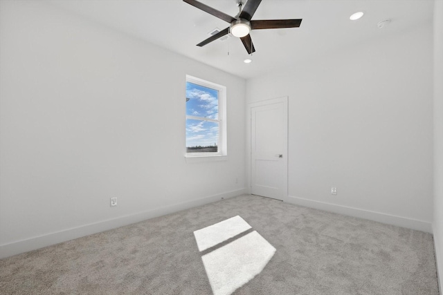 unfurnished room with baseboards, recessed lighting, and light colored carpet