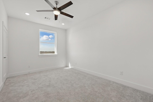 unfurnished room featuring light carpet, baseboards, visible vents, and recessed lighting