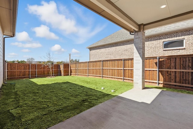 view of yard featuring a patio area and a fenced backyard