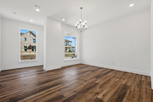 unfurnished dining area featuring dark wood-style floors, baseboards, visible vents, and recessed lighting