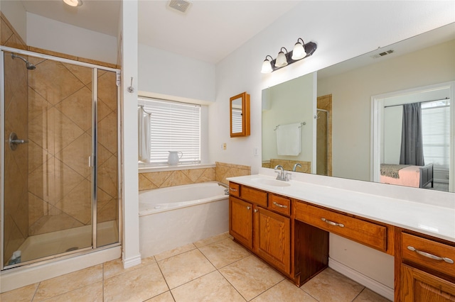 bathroom featuring plenty of natural light, plus walk in shower, and tile patterned flooring