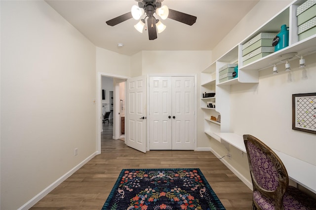 office with hardwood / wood-style floors, built in desk, and ceiling fan