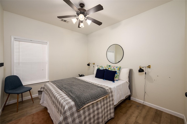 bedroom with dark wood-type flooring and ceiling fan