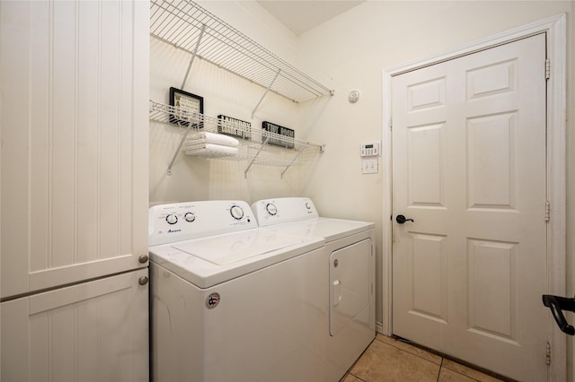 washroom with separate washer and dryer and light tile patterned flooring