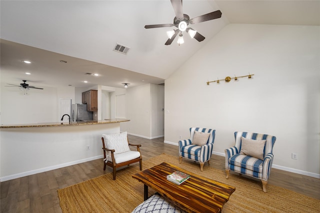 living room featuring vaulted ceiling, sink, ceiling fan, and dark hardwood / wood-style flooring