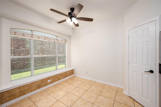 unfurnished room with light tile patterned floors and ceiling fan