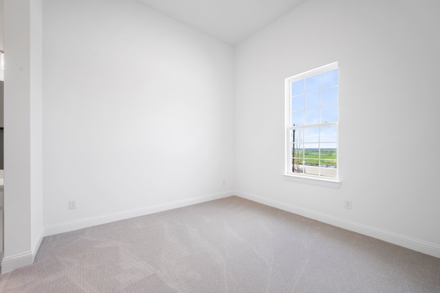 carpeted empty room with baseboards