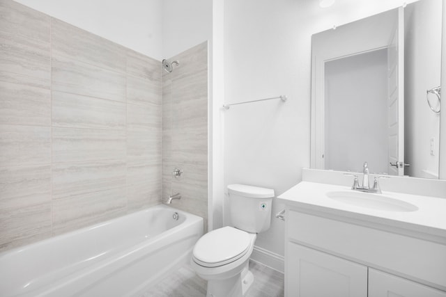 bathroom featuring toilet, washtub / shower combination, baseboards, and vanity