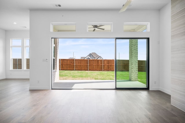 entryway with visible vents, ceiling fan, and wood finished floors