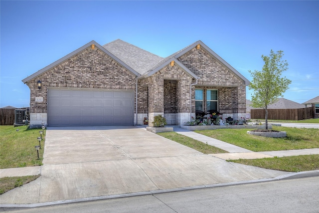 view of front of property featuring a garage and a front lawn