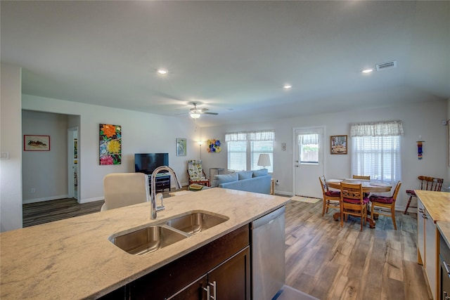 kitchen with sink, dark brown cabinets, stainless steel dishwasher, dark hardwood / wood-style floors, and ceiling fan