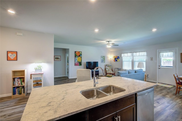 kitchen with sink, dishwasher, ceiling fan, light stone countertops, and dark hardwood / wood-style flooring