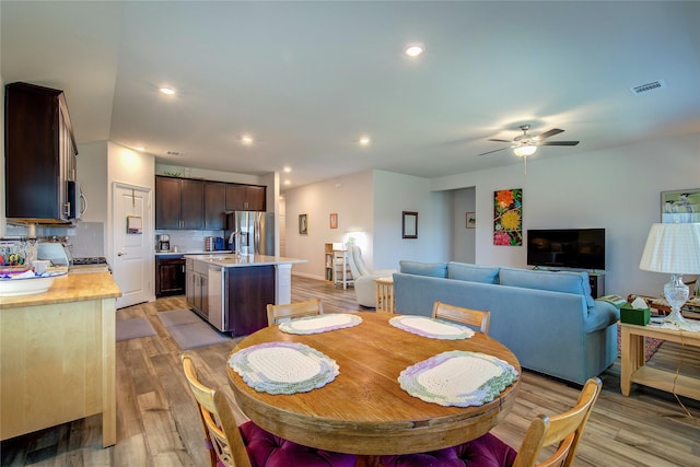 dining room featuring ceiling fan and light wood-type flooring