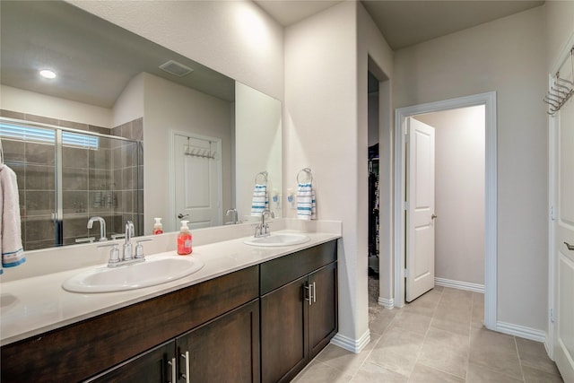 bathroom with walk in shower, vanity, and tile patterned flooring