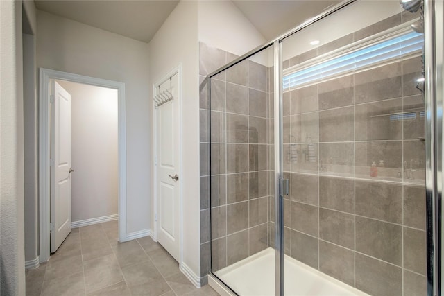 bathroom with tile patterned flooring and a shower with door