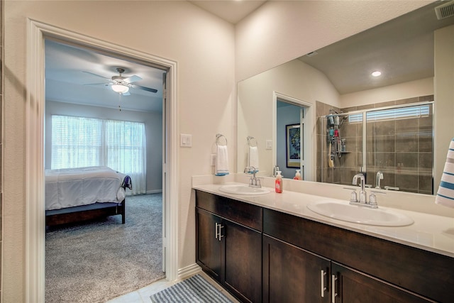 bathroom featuring ceiling fan, vanity, a shower with door, and tile patterned floors