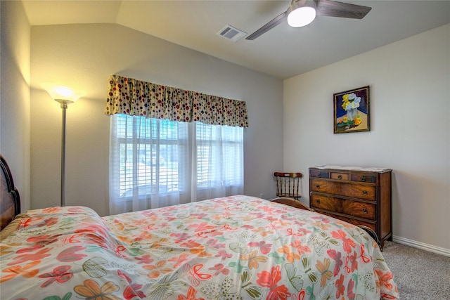 bedroom with ceiling fan, lofted ceiling, and carpet floors